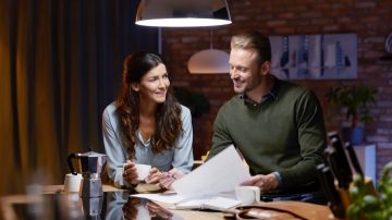 deux personnes lisant le journal sous un luminaire à intensité variable