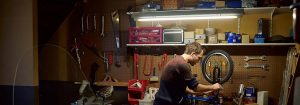 "LED tube light illuminating garage interior, showcasing energy-efficient lighting for storage spaces with bicycles and household items."