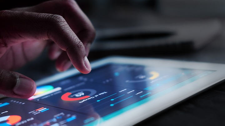 Close-up of a hand interacting with a tablet