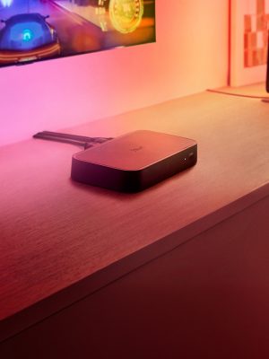 A Philips Hue Play HDMI sync box 8K connected to a TV and Philips Hue smart lighting.
