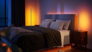 Bedroom with wall wash lighting casting a soft ambient glow in warm tones, highlighting the bed and nightstands.