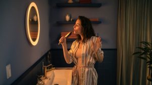 Frau, die in einen Philips Hue Adore Bathroom-Spiegel schaut