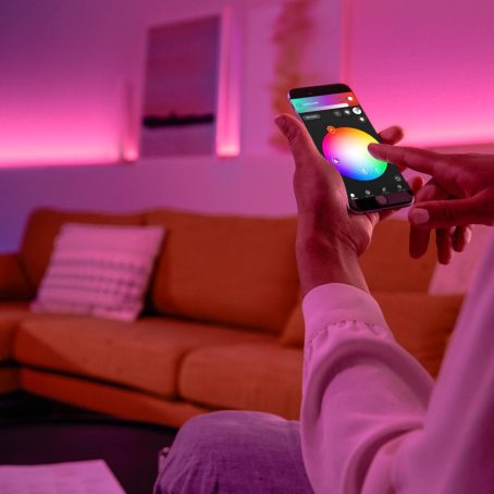 Hand holding mobile device with Hue app