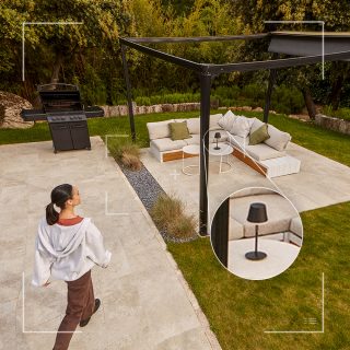 A video recording from a Hue 2K Secure camera showing a woman walking across a patio.