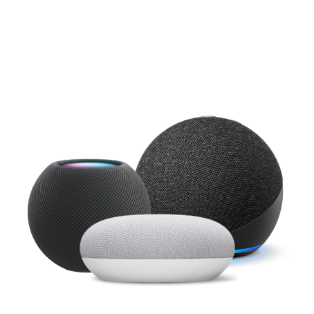 Close up of Apple HomePod Mini, Google Nest Mini, and Amazon Echo Dot on white background