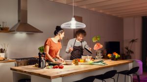 Couple cooking underneath pendant light