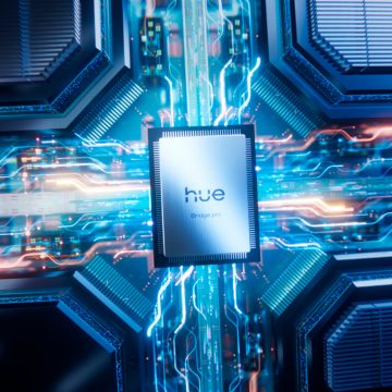 A Hue Chip Pro inside a new Hue Bridge Pro pulsating with blue and pink currents of energy.