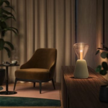 Triangular smart bulb in table lamp in living room with chair