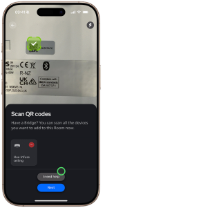 L’application Hue affiche l’écran Numériser les codes QR avec un indicateur au-dessus du bouton Suivant.